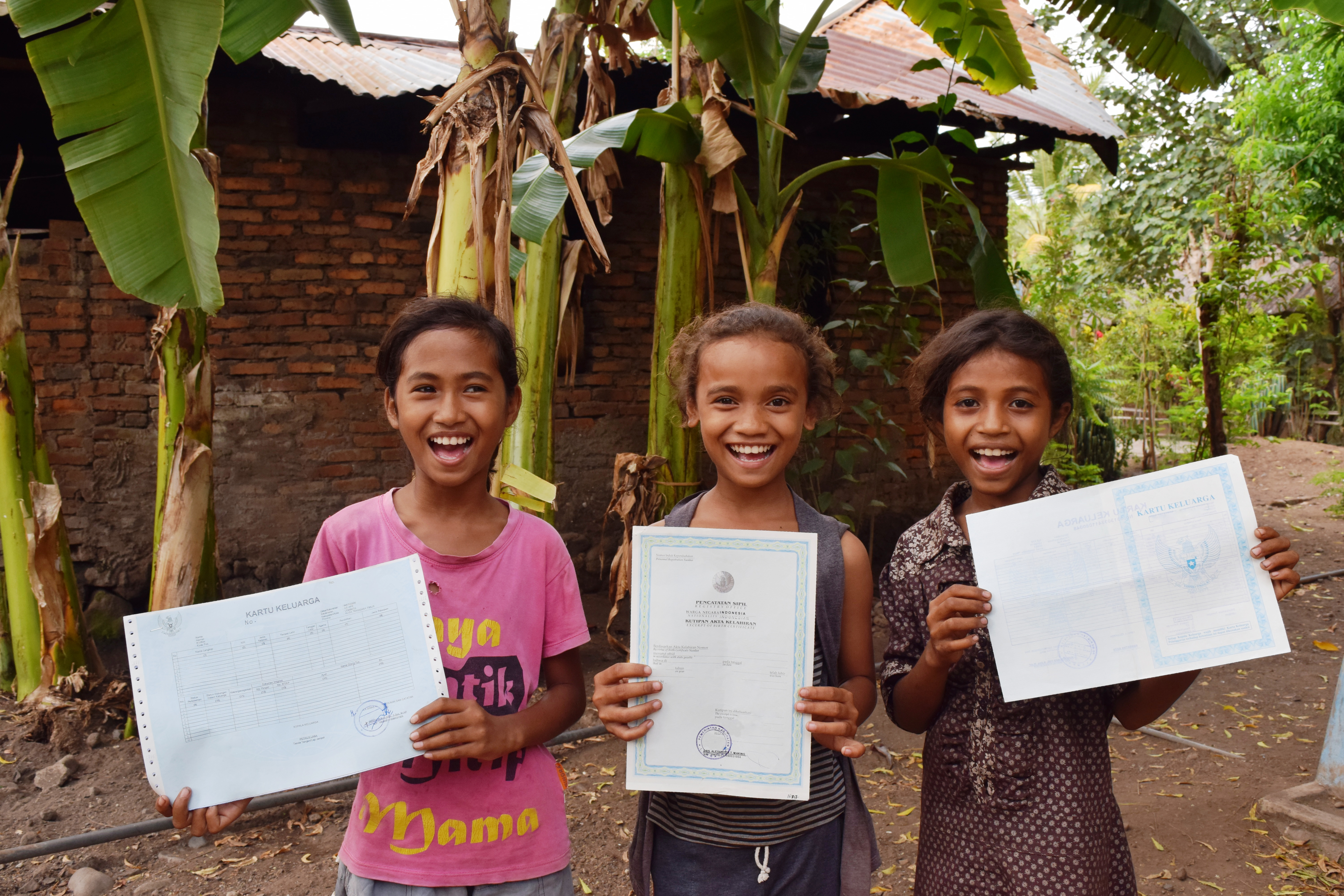 Girls show of their new birth certificates