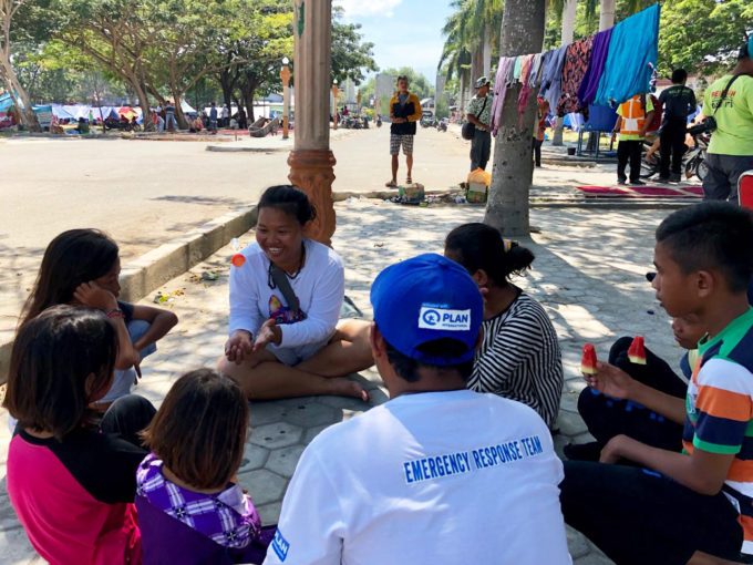 Plan staff talking to children