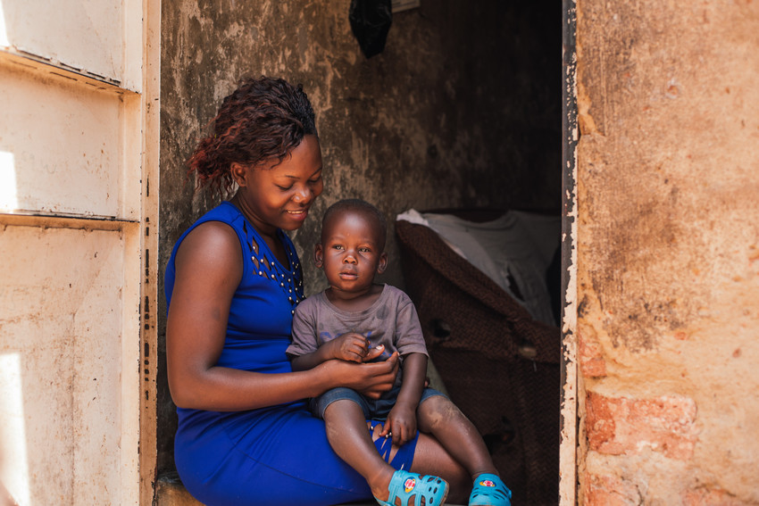 Young woman with her son in her house in Kampala