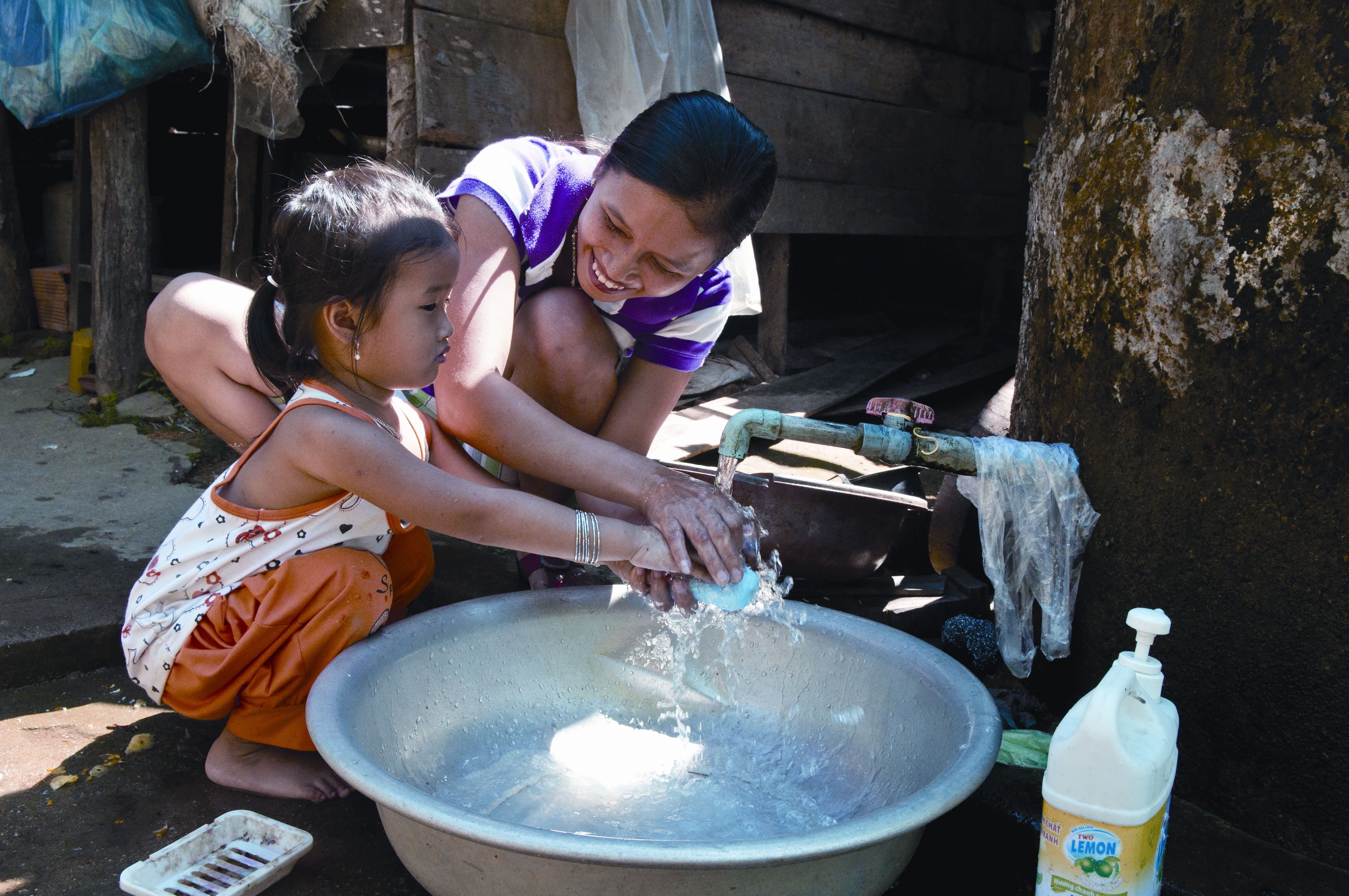 Woman and child in Vietnam washing their hands 